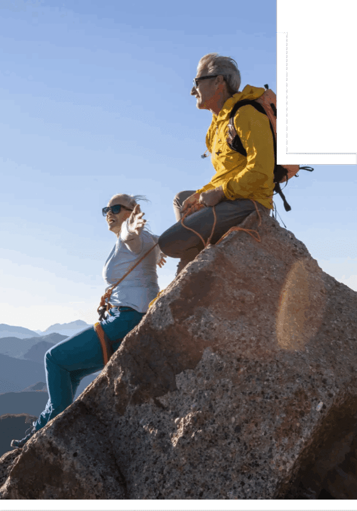 Two climbers resting on a mountain peak.